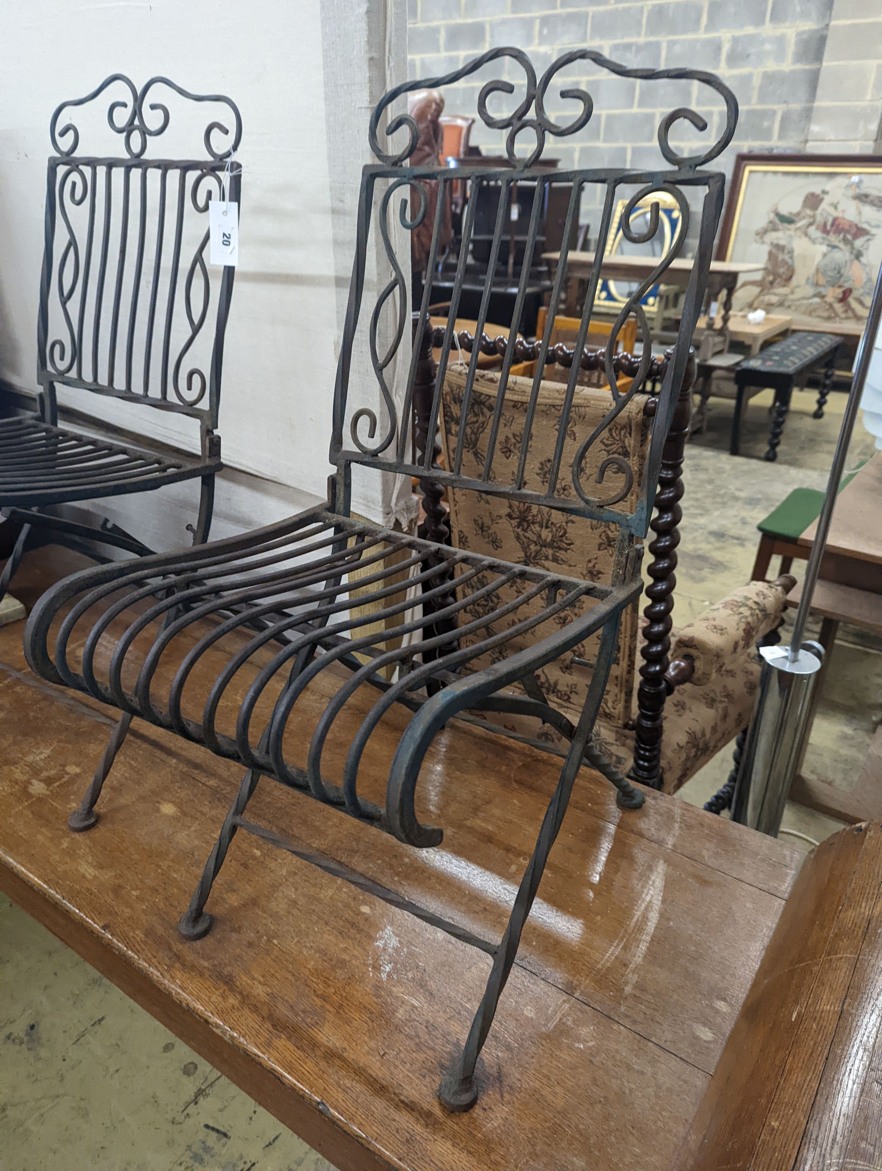 A pair of wrought iron folding garden chairs, width 38cm, height 89cm